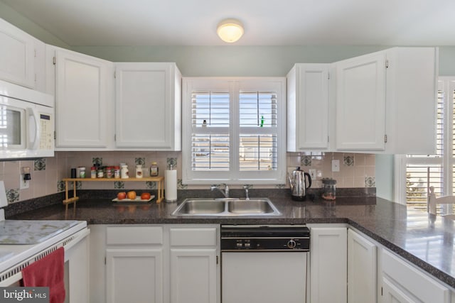 kitchen featuring tasteful backsplash, white cabinets, white appliances, and a sink