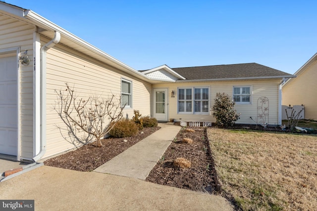 view of front of property featuring a garage and a front lawn