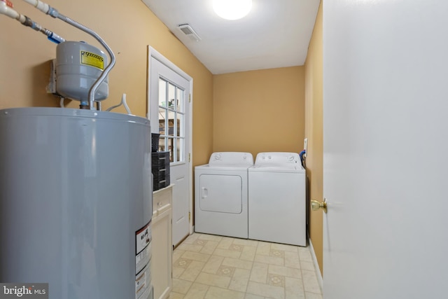 laundry room featuring laundry area, gas water heater, independent washer and dryer, and visible vents