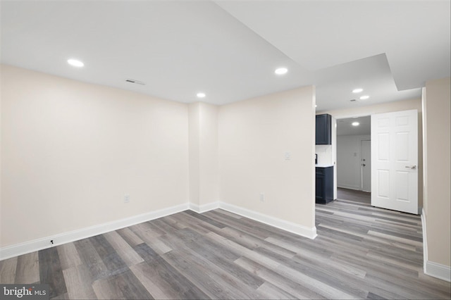 interior space with visible vents, recessed lighting, wood finished floors, and baseboards