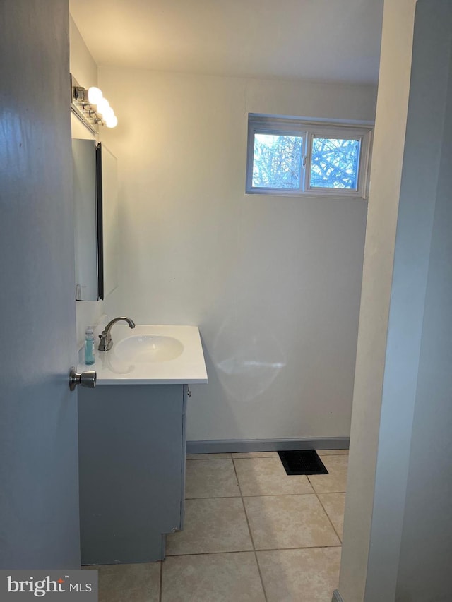 bathroom featuring baseboards, vanity, and tile patterned flooring