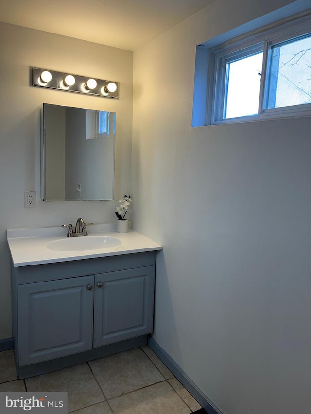 bathroom with tile patterned floors, vanity, and baseboards