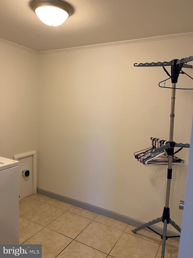 laundry room featuring light tile patterned floors, baseboards, washer / dryer, and ornamental molding