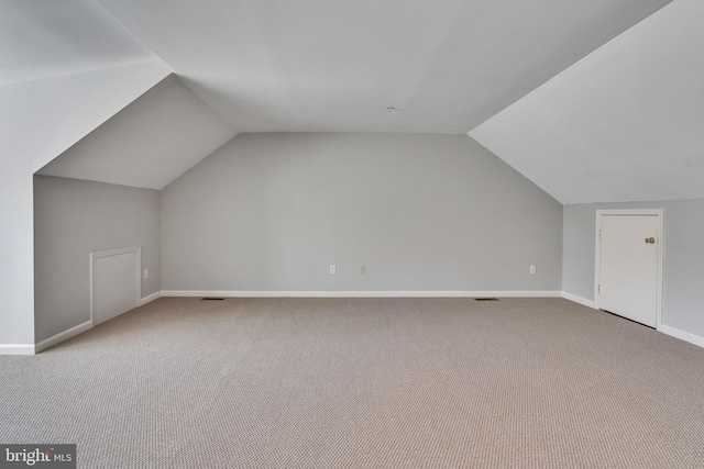 bonus room featuring baseboards, carpet, and lofted ceiling