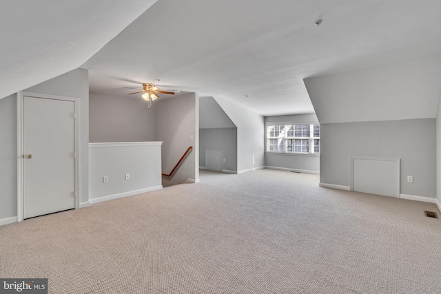 additional living space featuring baseboards, carpet flooring, and vaulted ceiling