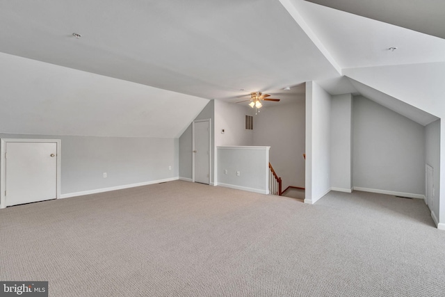 bonus room featuring baseboards, lofted ceiling, carpet, and a ceiling fan