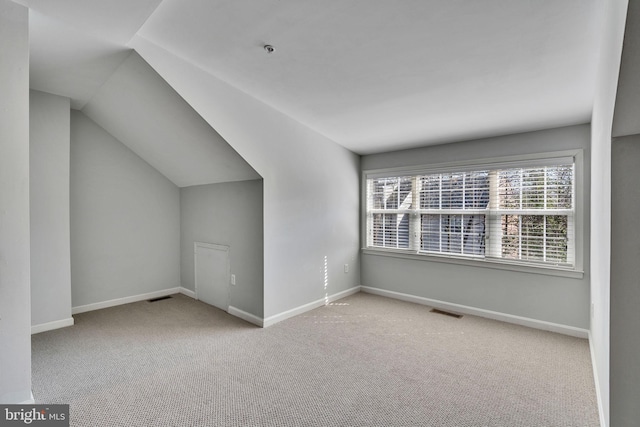 bonus room with vaulted ceiling, visible vents, baseboards, and carpet floors