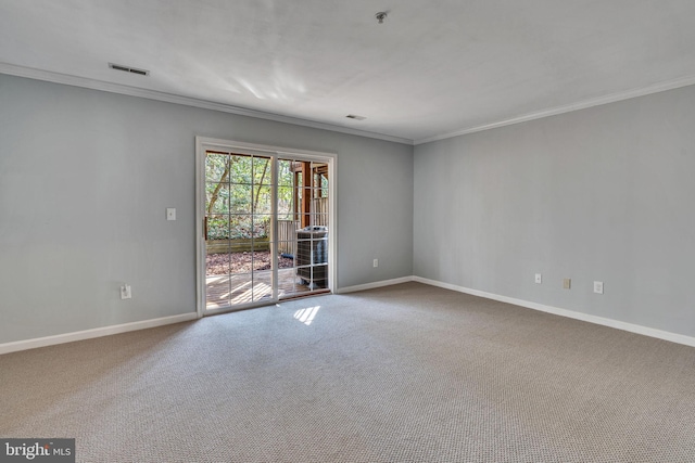 unfurnished room featuring visible vents, baseboards, carpet, and ornamental molding