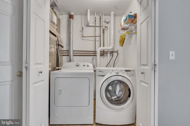 washroom featuring separate washer and dryer and laundry area