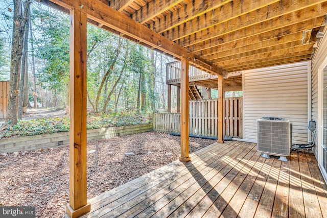 wooden deck featuring stairway and central AC