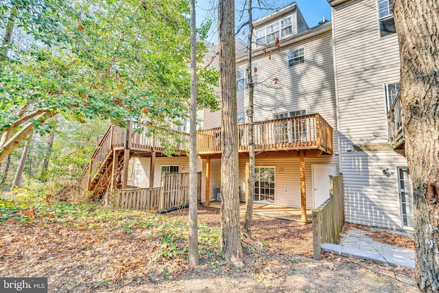 rear view of property featuring a patio and a deck