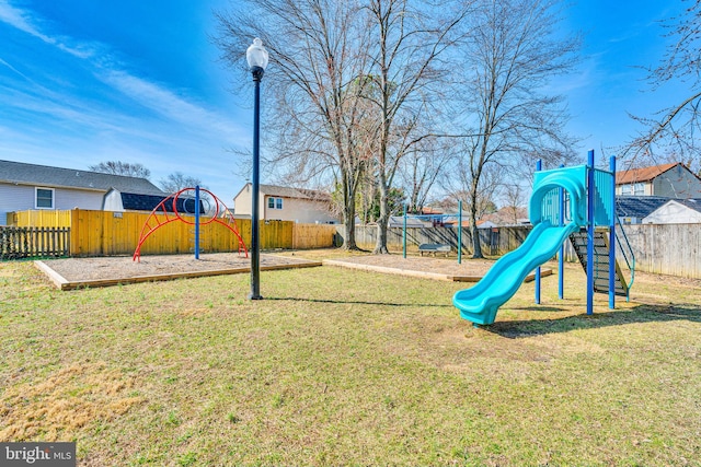 community playground featuring a yard and a fenced backyard