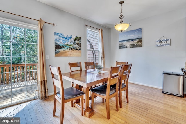 dining room featuring light wood-style flooring and baseboards