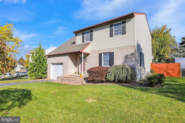 view of front of home with aphalt driveway, fence, a front yard, an attached garage, and brick siding