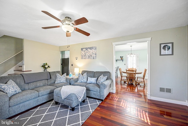 living room with visible vents, a ceiling fan, hardwood / wood-style floors, baseboards, and stairs