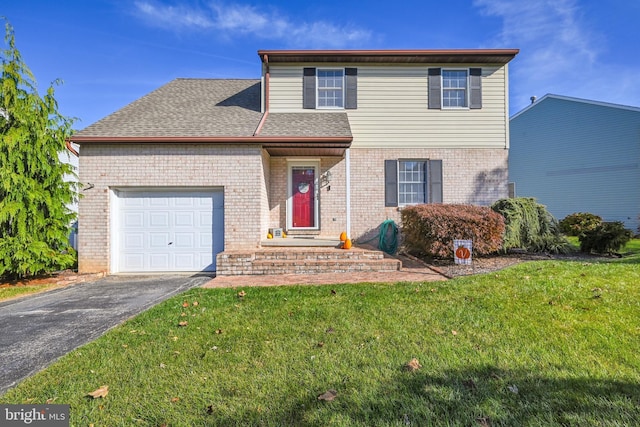 traditional home featuring driveway, roof with shingles, a front yard, an attached garage, and brick siding