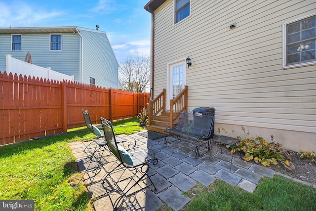 view of patio featuring entry steps and a fenced backyard