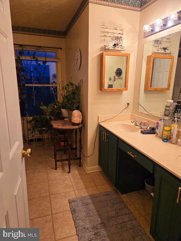 bathroom with tile patterned flooring and vanity
