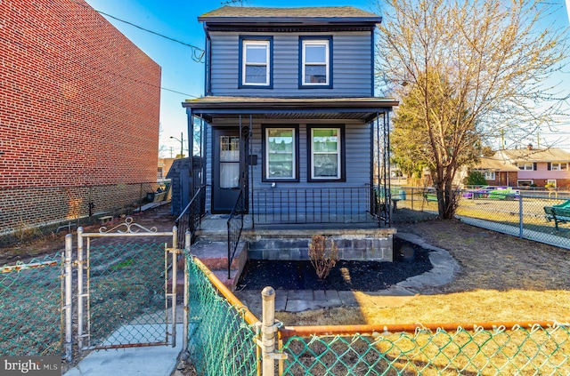 view of front of house with a porch, fence private yard, roof with shingles, and a gate