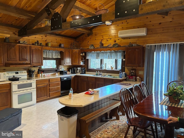 kitchen featuring light floors, wood walls, light countertops, a wall unit AC, and white appliances