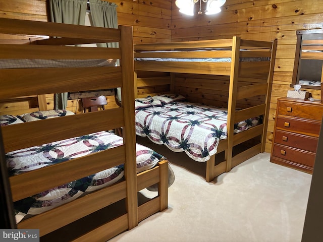 carpeted bedroom with wooden walls