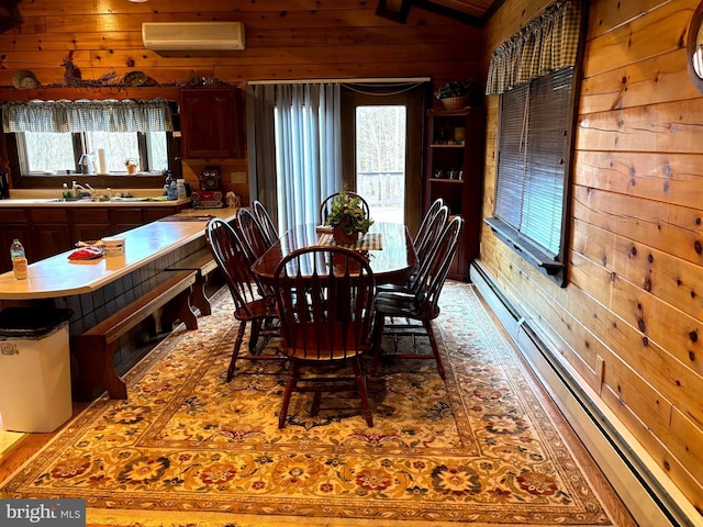 dining space featuring a wall mounted air conditioner, plenty of natural light, lofted ceiling, and wood walls