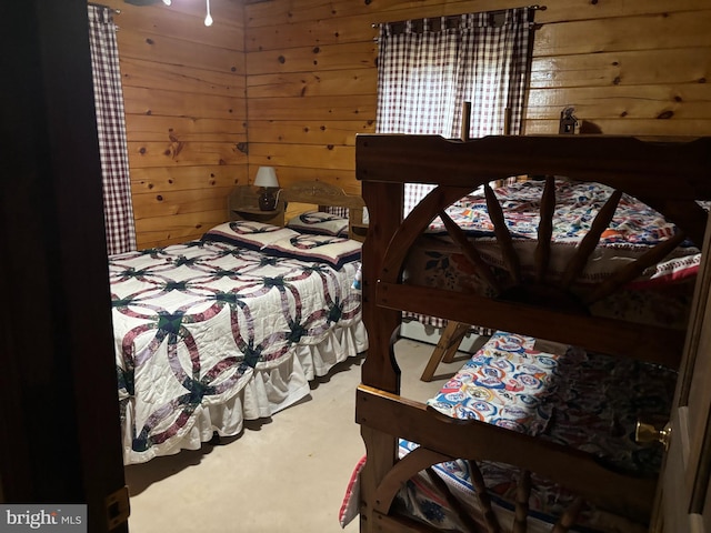 carpeted bedroom with wooden walls