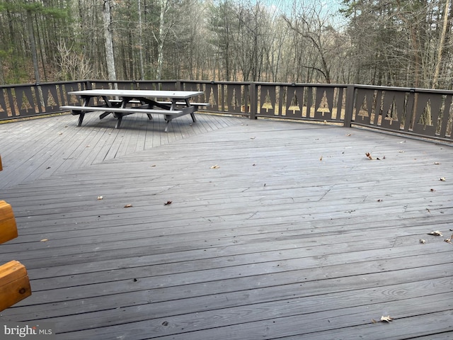 wooden terrace with outdoor dining space