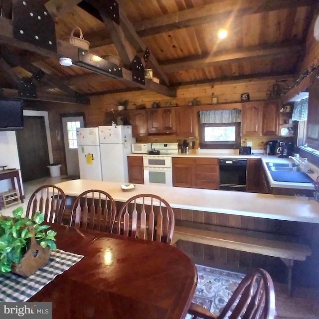 kitchen featuring white appliances, vaulted ceiling with beams, a sink, light countertops, and wooden ceiling