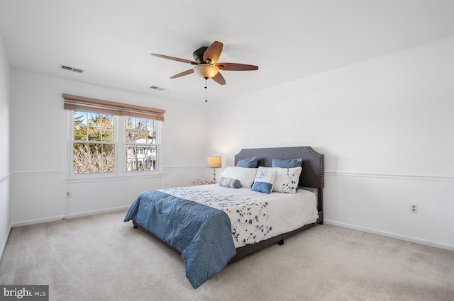 carpeted bedroom featuring baseboards, visible vents, and ceiling fan