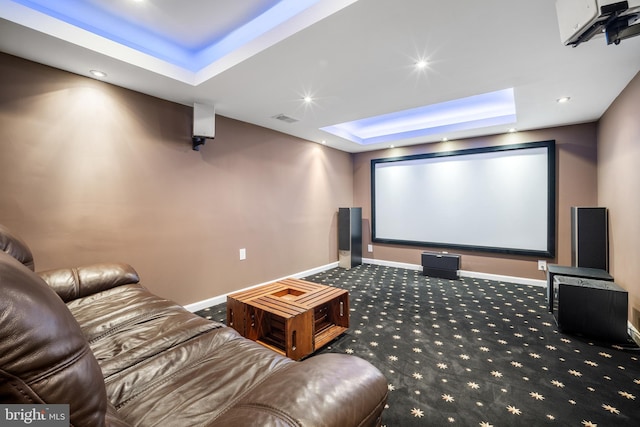 carpeted cinema room with recessed lighting, a tray ceiling, baseboards, and visible vents