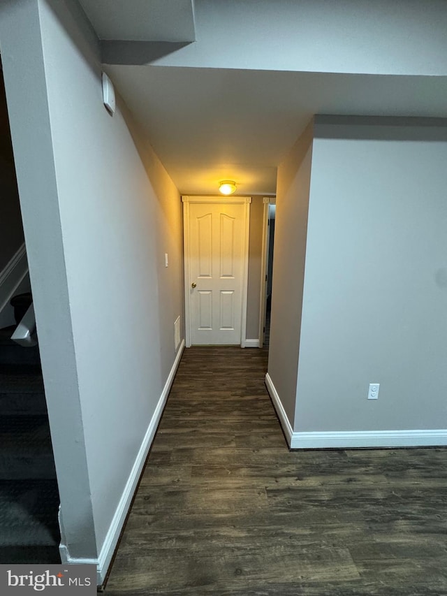 hall featuring dark wood-style floors, visible vents, stairs, and baseboards