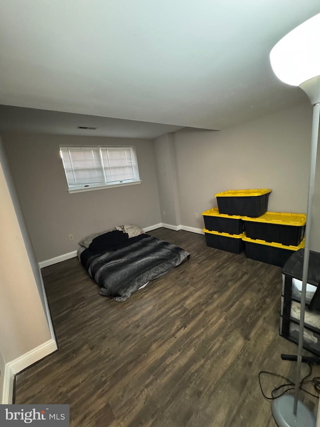 bedroom featuring dark wood finished floors, baseboards, and visible vents