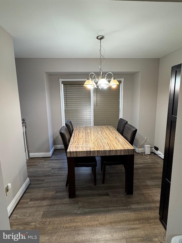 dining area featuring dark wood-style floors and baseboards