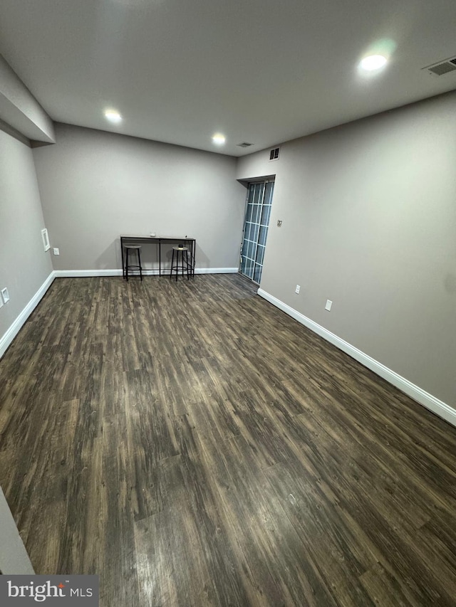 basement with recessed lighting, visible vents, baseboards, and wood finished floors