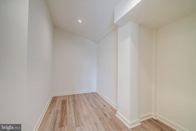 empty room with recessed lighting, baseboards, and wood finished floors