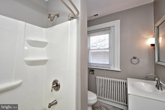 bathroom featuring visible vents, radiator, toilet, shower / bathtub combination, and vanity