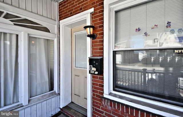 entrance to property with brick siding and board and batten siding