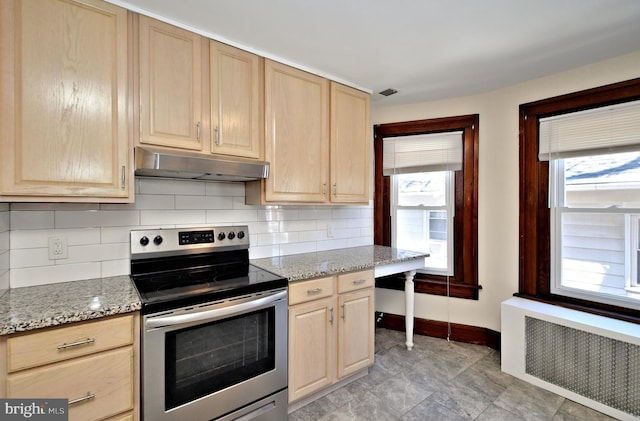 kitchen with radiator, stainless steel electric range, light brown cabinets, and under cabinet range hood