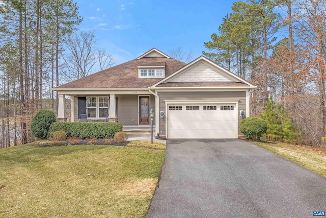 craftsman-style home featuring a front lawn, a porch, roof with shingles, driveway, and an attached garage