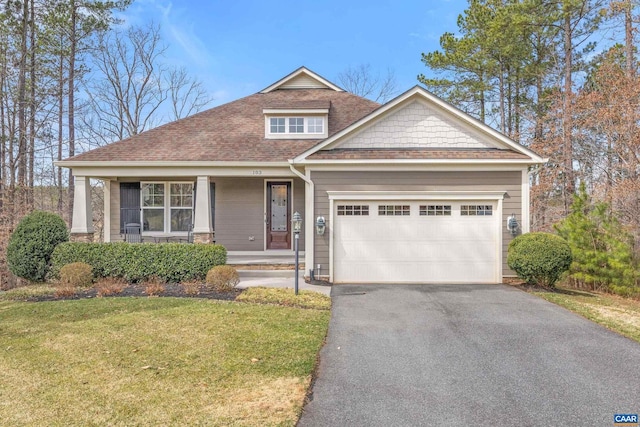 craftsman inspired home with a shingled roof, aphalt driveway, a porch, a front yard, and a garage