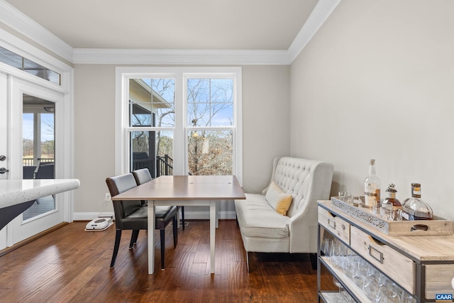 dining space with baseboards, ornamental molding, and dark wood-style flooring