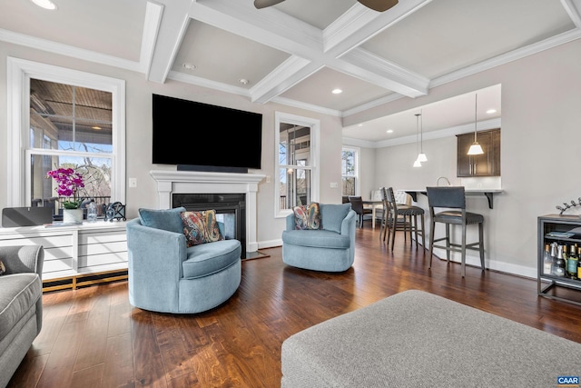 living area with a glass covered fireplace, beamed ceiling, dark wood-style floors, and coffered ceiling