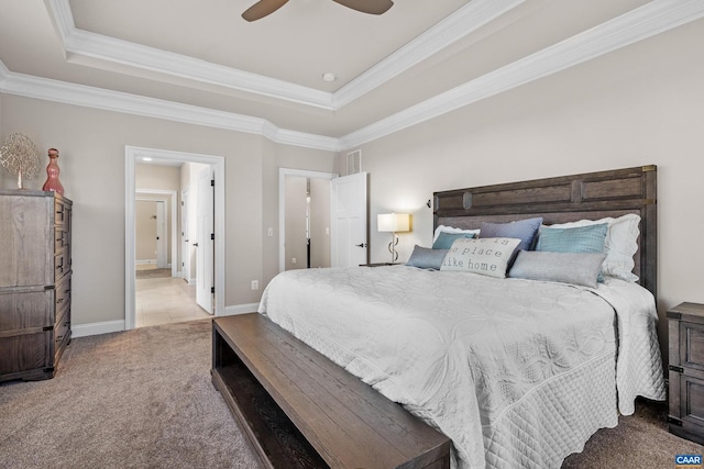 bedroom featuring a raised ceiling, ensuite bath, carpet flooring, crown molding, and baseboards