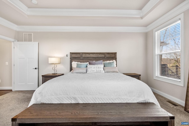 bedroom with a tray ceiling, baseboards, visible vents, and carpet floors