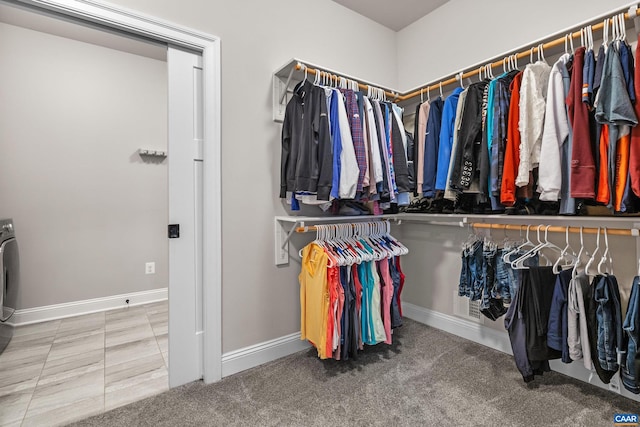 walk in closet featuring carpet floors