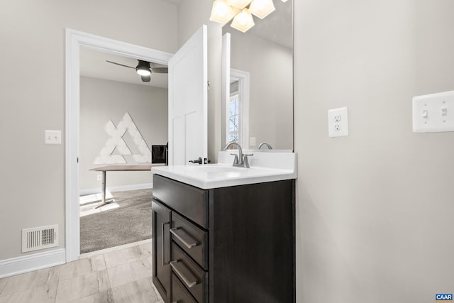 bathroom with vanity, baseboards, visible vents, and marble finish floor