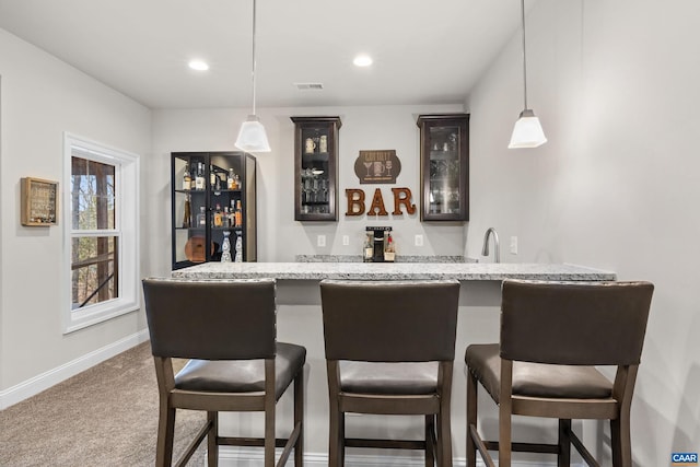 bar featuring baseboards, pendant lighting, carpet floors, recessed lighting, and wet bar