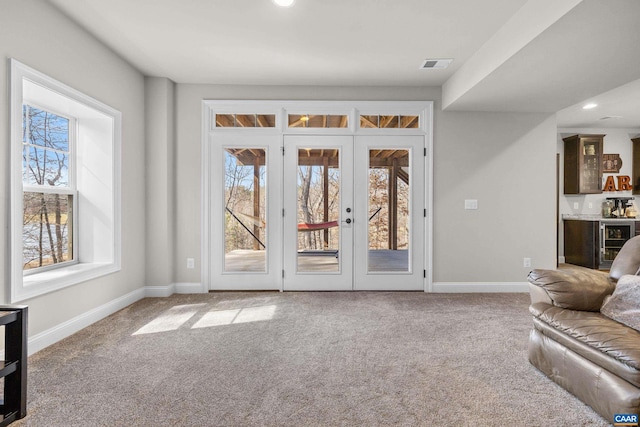 entryway featuring visible vents, beverage cooler, recessed lighting, carpet, and baseboards