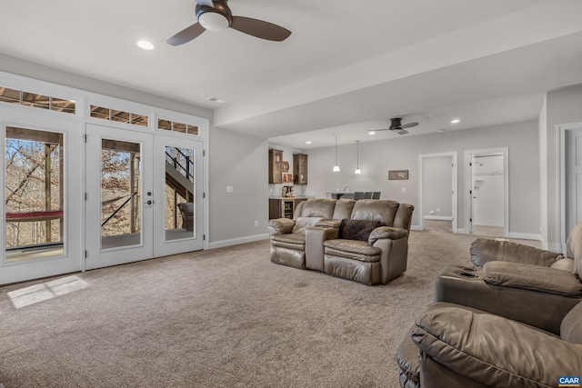 carpeted living room with visible vents, baseboards, ceiling fan, recessed lighting, and french doors